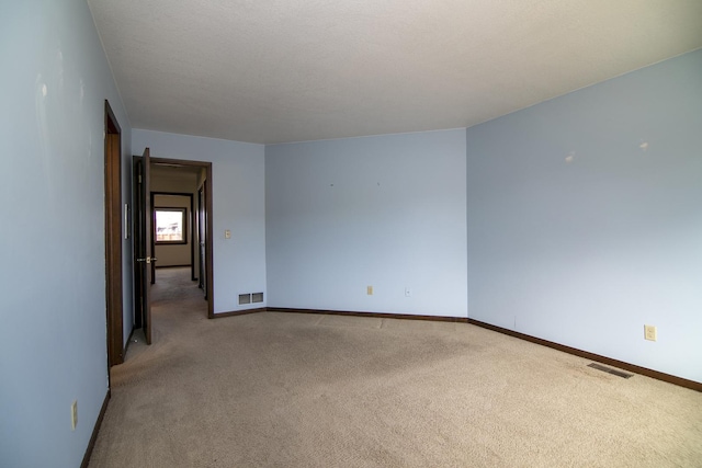 empty room featuring light colored carpet