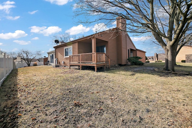 exterior space with a wooden deck and a front yard