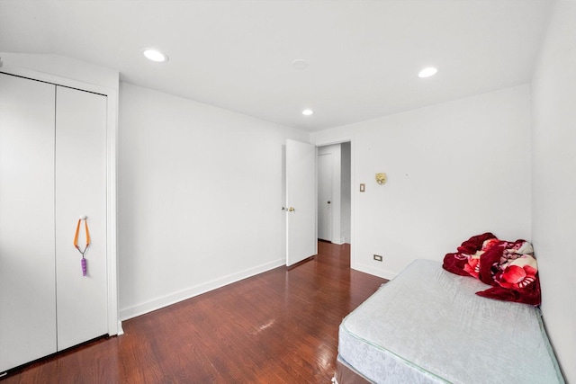 bedroom with dark hardwood / wood-style floors