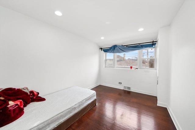 bedroom featuring dark hardwood / wood-style flooring