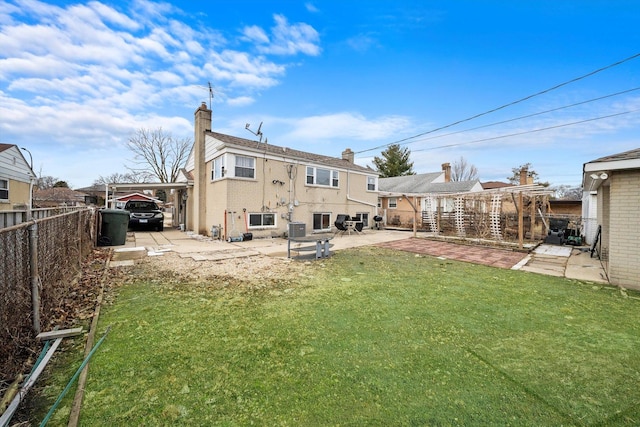 back of property with central AC unit, a lawn, and a patio