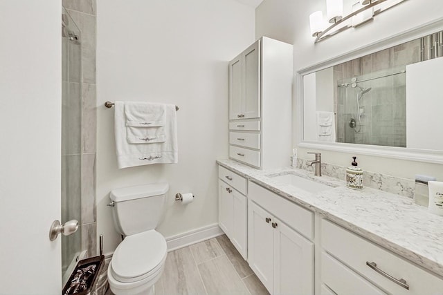 bathroom with vanity, an enclosed shower, and toilet