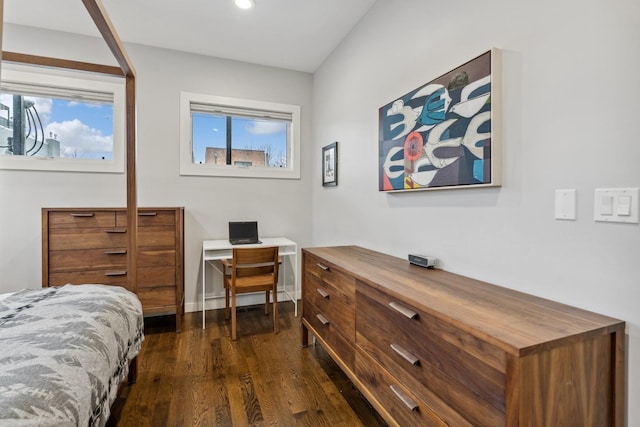 bedroom with dark hardwood / wood-style flooring