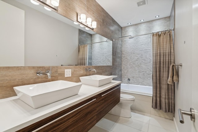 full bathroom with backsplash, vanity, shower / tub combo, toilet, and tile patterned floors