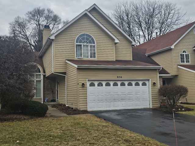 front facade with a garage and a front lawn