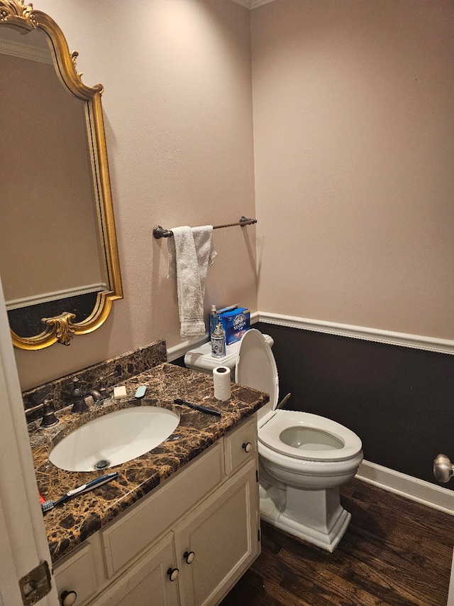 bathroom with vanity, hardwood / wood-style flooring, and toilet