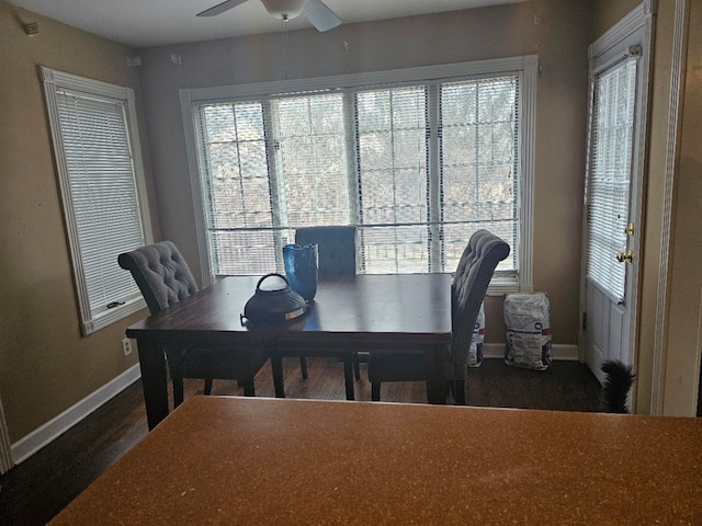 dining space with dark wood-type flooring and ceiling fan