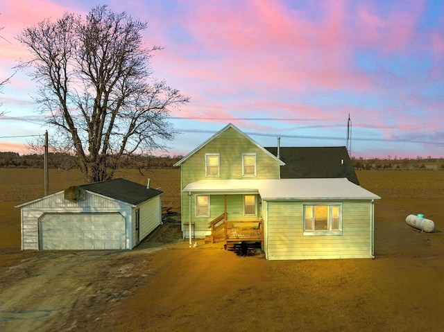 rear view of house with a garage and an outdoor structure