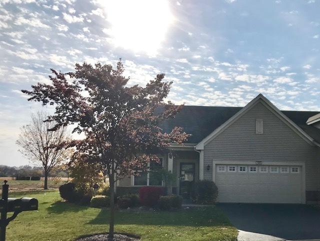 view of front of property with a garage and a front lawn