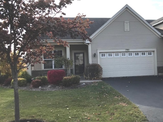 view of front facade with a garage and a front lawn