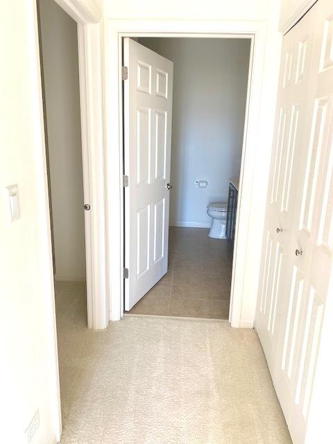 hall featuring light tile patterned floors