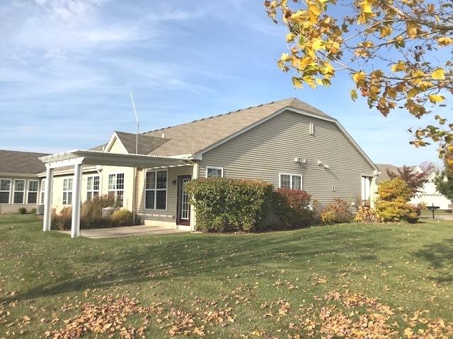 rear view of house featuring a yard, a pergola, and a patio area