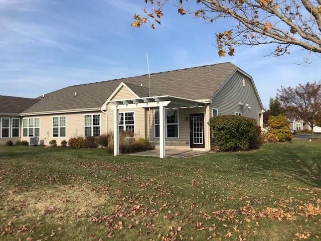 back of property with a patio and a lawn