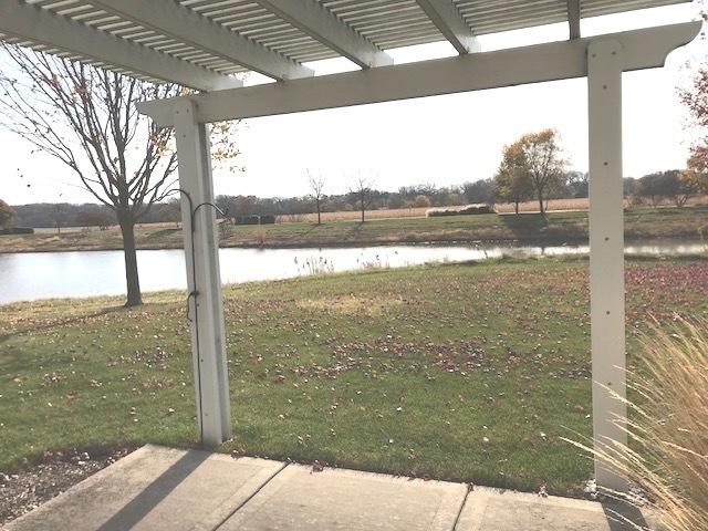 view of yard featuring a water view and a pergola