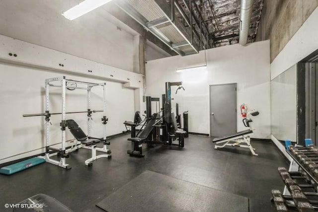 exercise room with a high ceiling