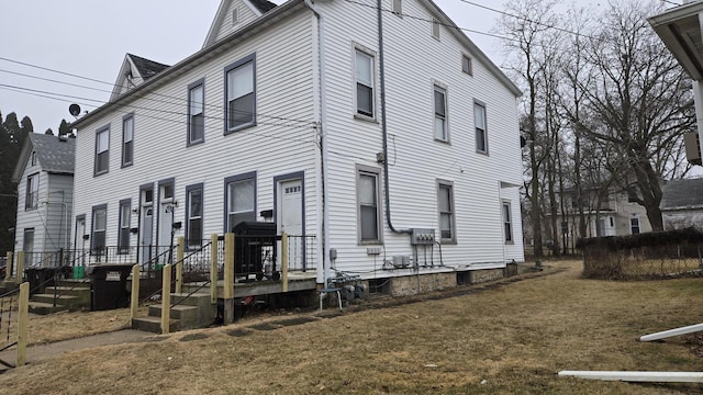 view of side of home with a lawn