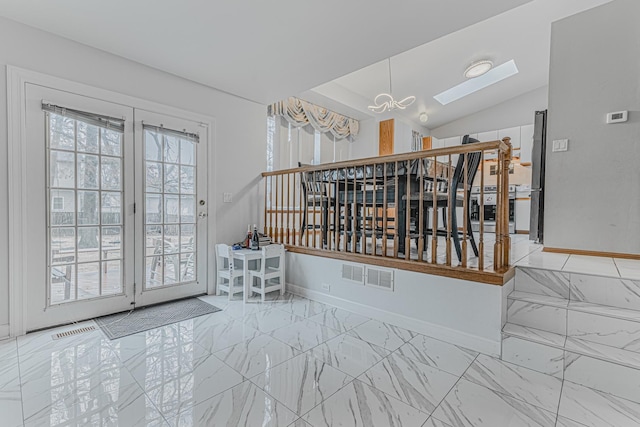 interior space featuring lofted ceiling with skylight