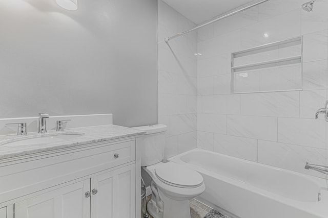 full bathroom with vanity, tiled shower / bath combo, and toilet