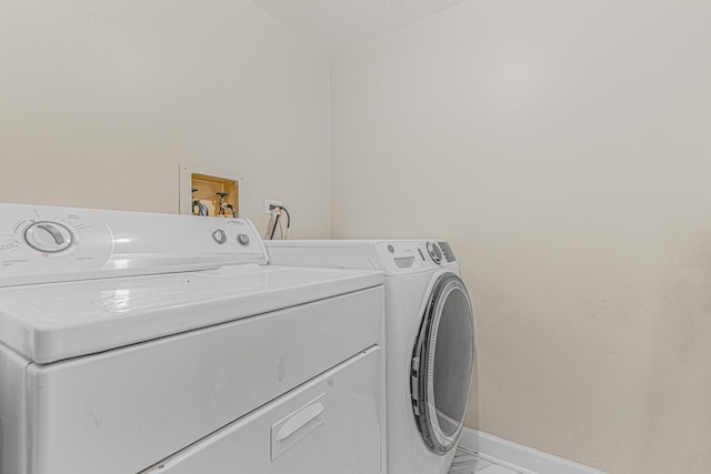 clothes washing area featuring separate washer and dryer