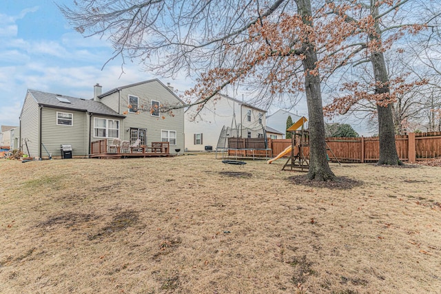 view of yard with a playground, central AC unit, a deck, and a trampoline