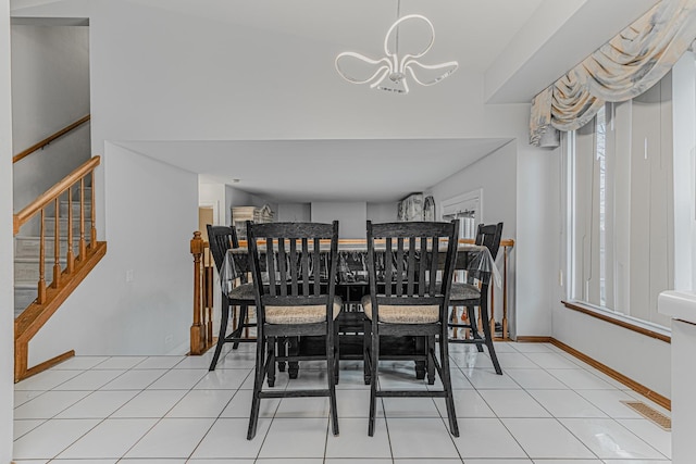 dining room with light tile patterned flooring and a chandelier