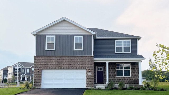 view of front of property featuring a garage and a front yard