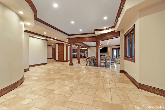 hall featuring decorative columns and ornamental molding