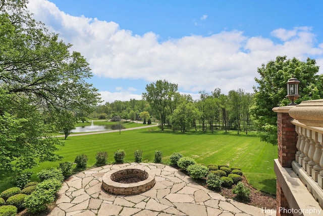 view of yard featuring a water view and a patio