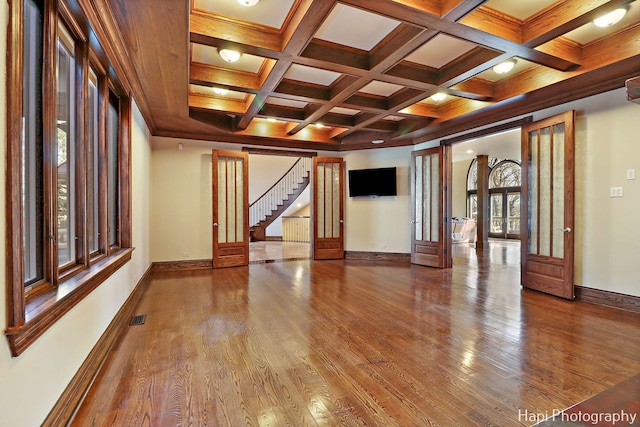 unfurnished room featuring beam ceiling, hardwood / wood-style flooring, and french doors