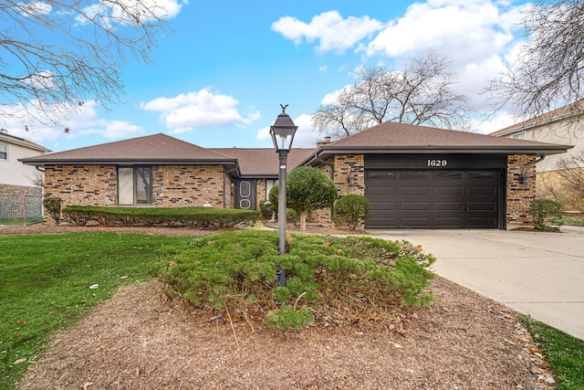 ranch-style house featuring a garage and a front yard