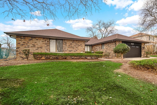 ranch-style home with a garage and a front lawn