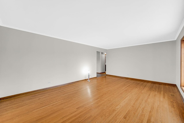 unfurnished room with crown molding and light wood-type flooring