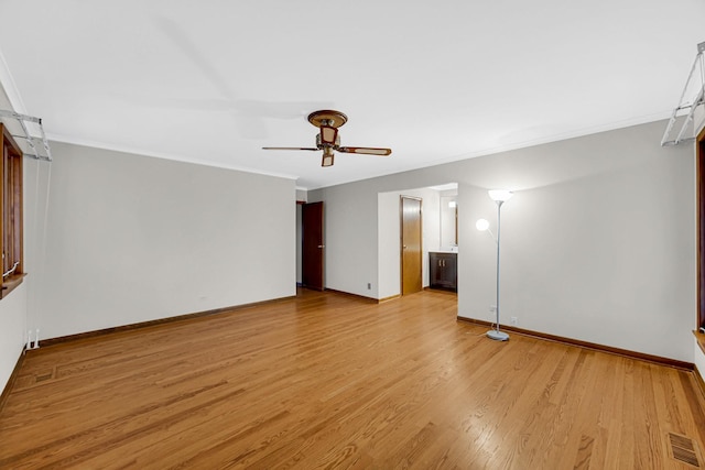 empty room featuring ceiling fan, ornamental molding, and light hardwood / wood-style floors