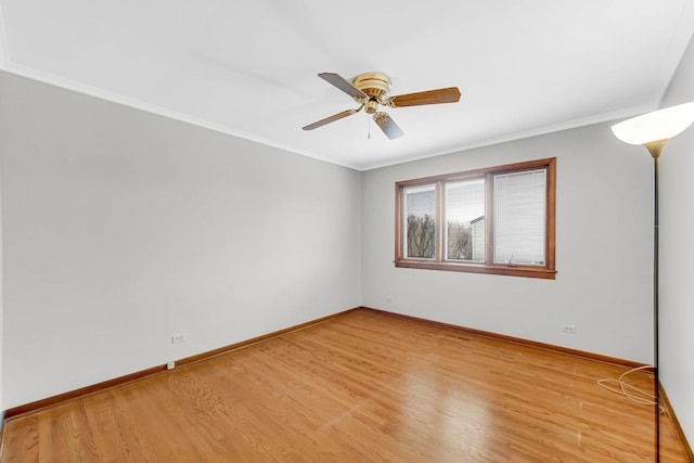 empty room with ceiling fan, crown molding, and light hardwood / wood-style floors