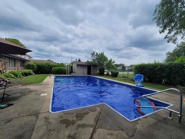 view of pool featuring a shed