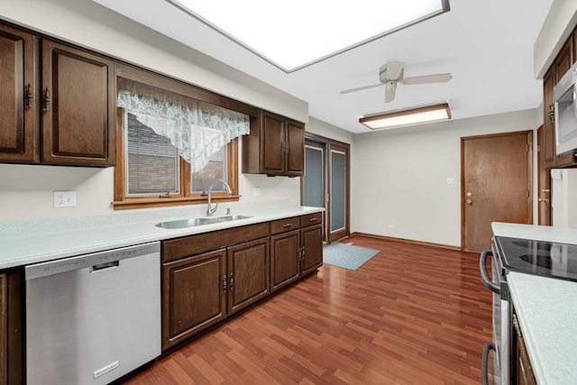 kitchen featuring sink, dark brown cabinets, appliances with stainless steel finishes, ceiling fan, and hardwood / wood-style floors