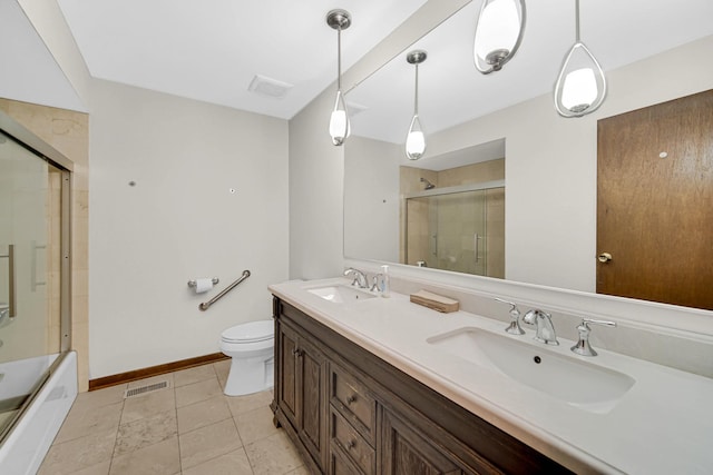 full bathroom featuring toilet, vanity, shower / bath combination with glass door, and tile patterned flooring