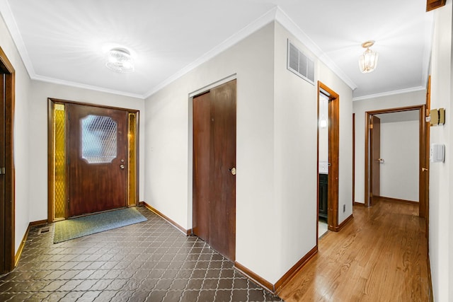 interior space featuring crown molding and hardwood / wood-style flooring