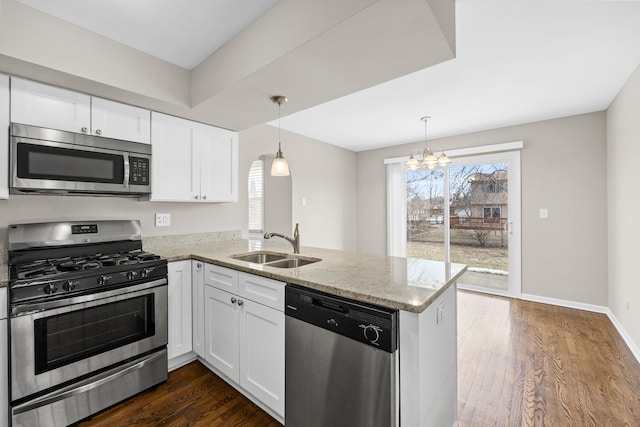 kitchen with stainless steel appliances, white cabinets, and kitchen peninsula