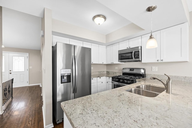 kitchen with white cabinetry, sink, decorative light fixtures, and appliances with stainless steel finishes