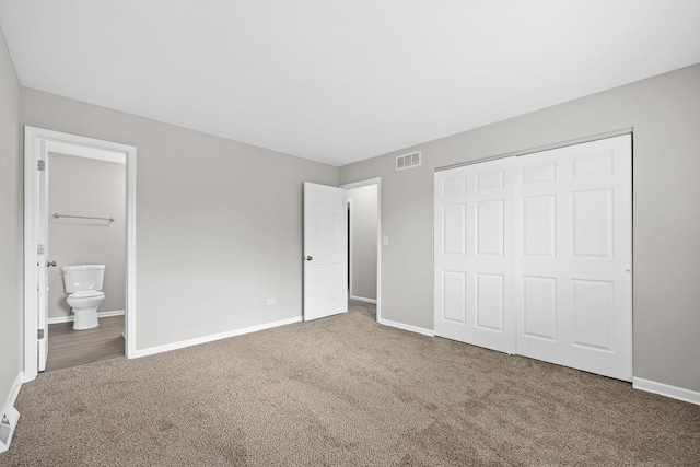 unfurnished bedroom with connected bathroom, carpet floors, and a closet