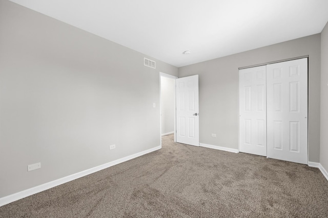 unfurnished bedroom featuring a closet and carpet flooring