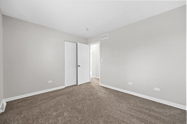 unfurnished bedroom featuring a closet and carpet