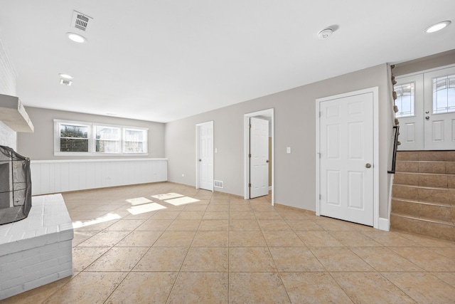 unfurnished living room featuring light tile patterned floors