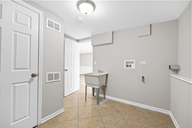 laundry room featuring light tile patterned flooring and washer hookup