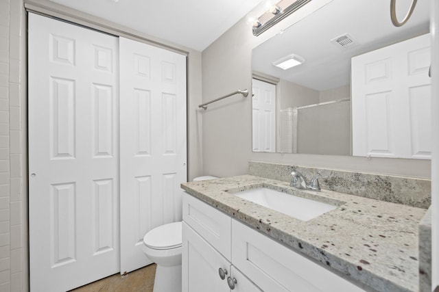 bathroom with vanity, toilet, and curtained shower