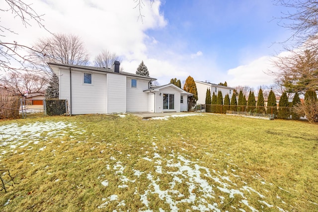 rear view of house featuring a patio and a yard