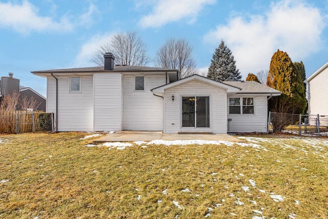 back of property with a patio and a lawn