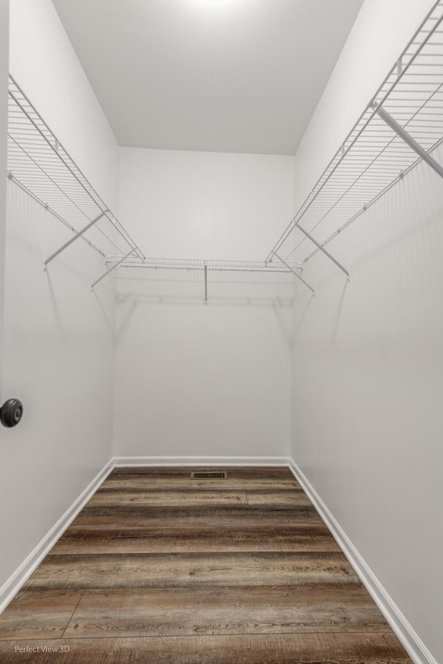 walk in closet featuring dark wood-type flooring and visible vents