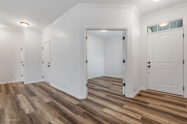 foyer entrance featuring baseboards, visible vents, ornamental molding, and wood finished floors